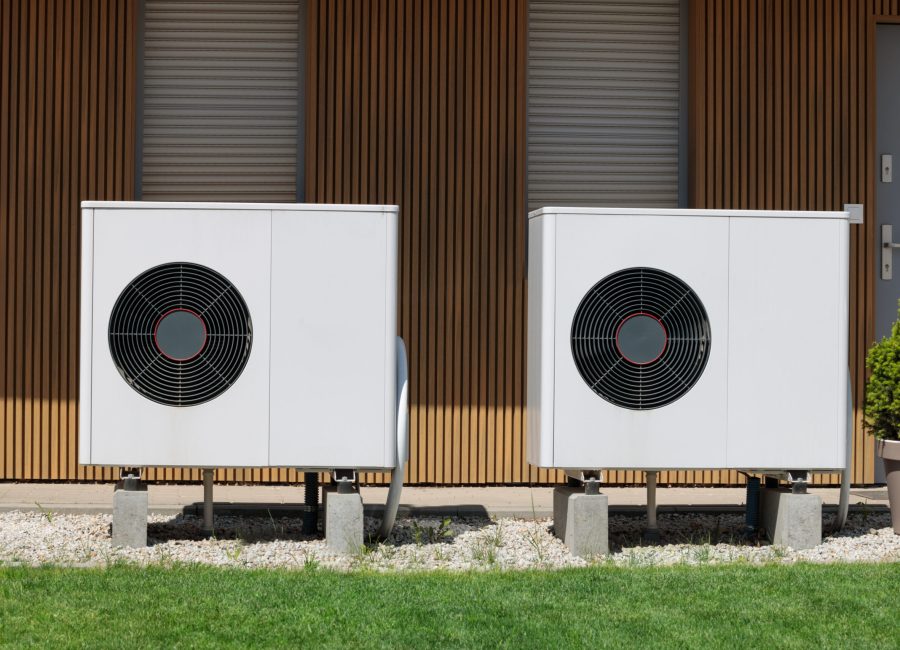 Air source heat pumps featured on the modern house front, presenting a Renewable energy concept